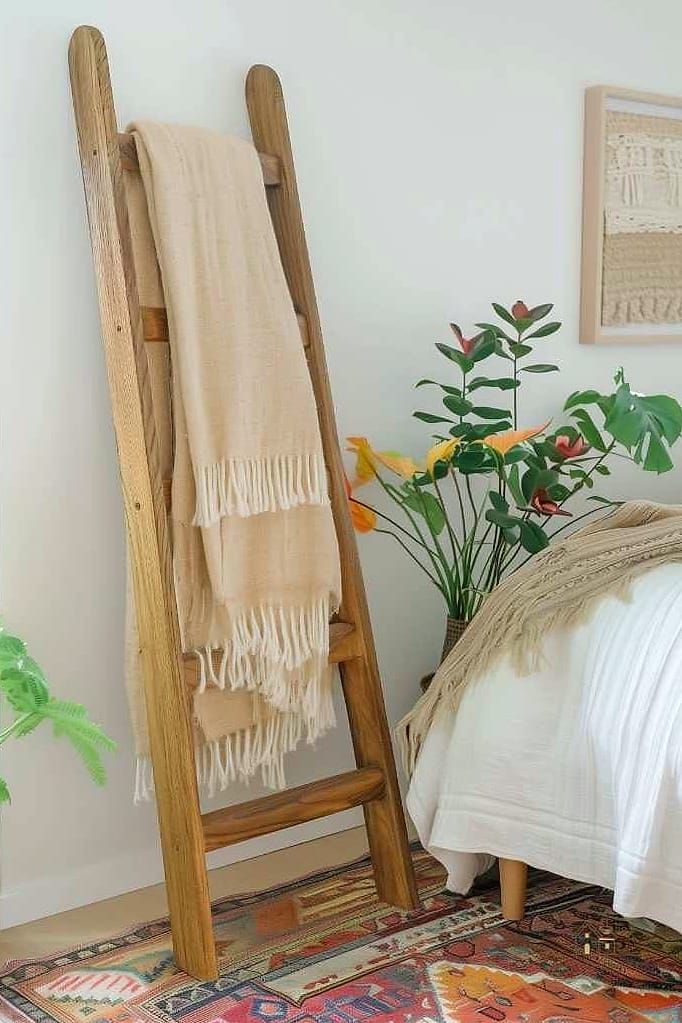 35 Chic Bedroom Storage Ideas for a Beautiful Home 27 A Blanket Ladder Combined with Wall Hooks