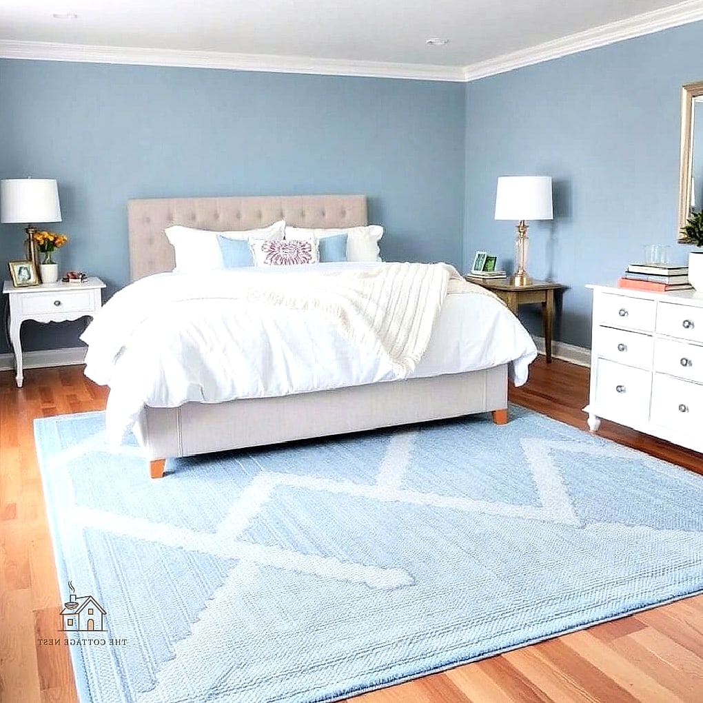 Blue and White Area Rug Layered on Wood Floors