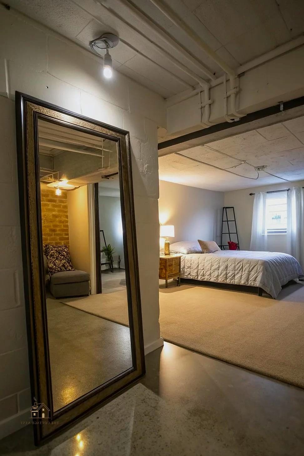 30 Amazing Basement Bedroom Ideas on a Budget 26 Use Mirrors to Bounce Light Around the Room