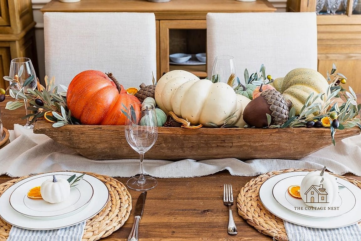 15 Creative Fall Dining Table Decor Ideas That Will Inspire You 11 A Centerpiece Bowl of Apples and Cinnamon Sticks