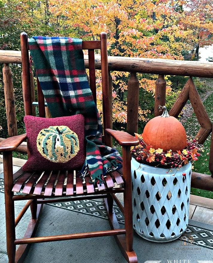 15 Creative Beautiful Fall Front Porch Decor Ideas That Will Inspire You 9 A Rocking Chair or Bench With Plaid Throw Pillows