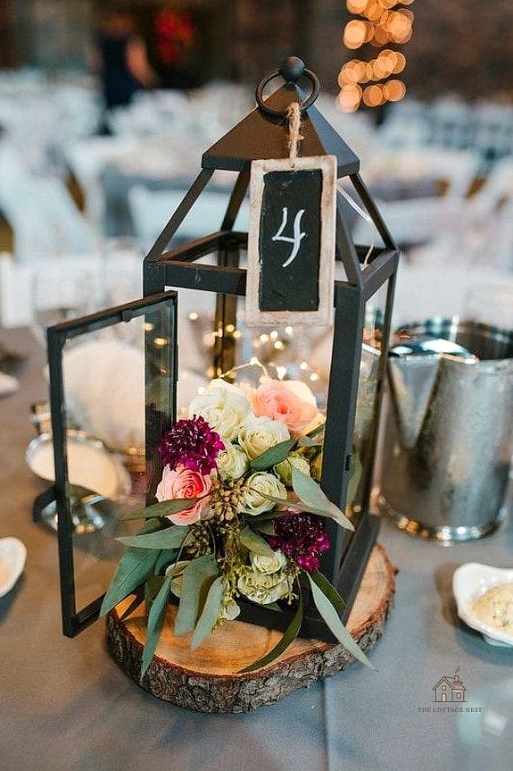 35 Beautiful Fall Table Centerpiece Ideas to Wow Your Guests 22 Rustic Lantern with Seasonal Foliage
